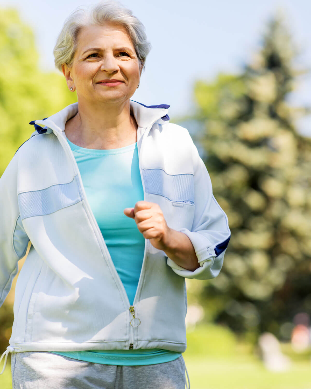 Senior Woman Running Along Summer Park