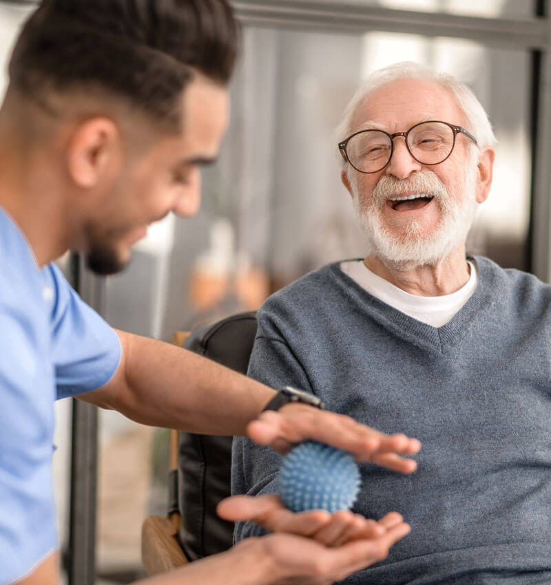 Patient Having His Hand Massaged With A Spiky Massage Ball