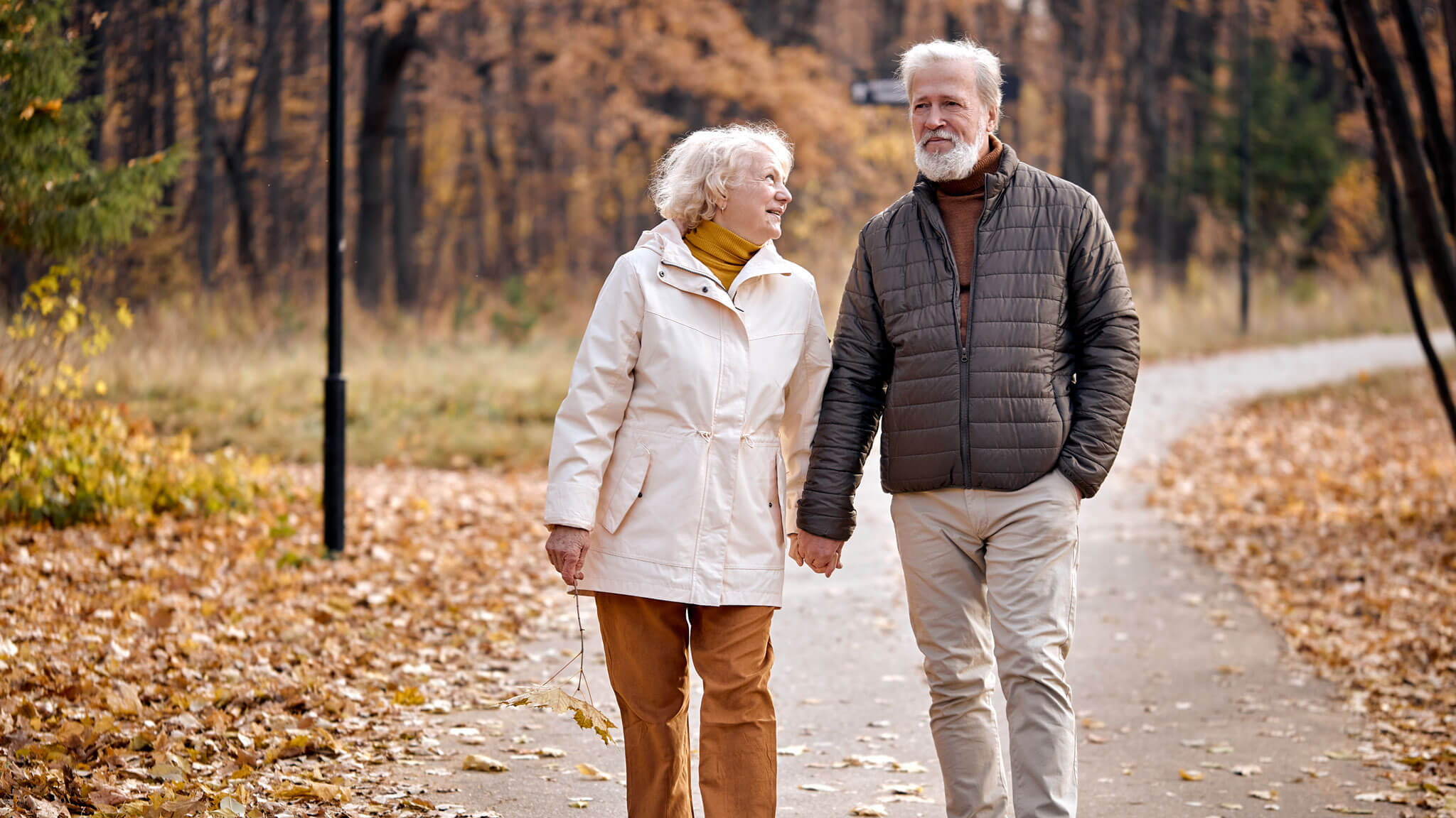 Elderly Couple Walking On Path